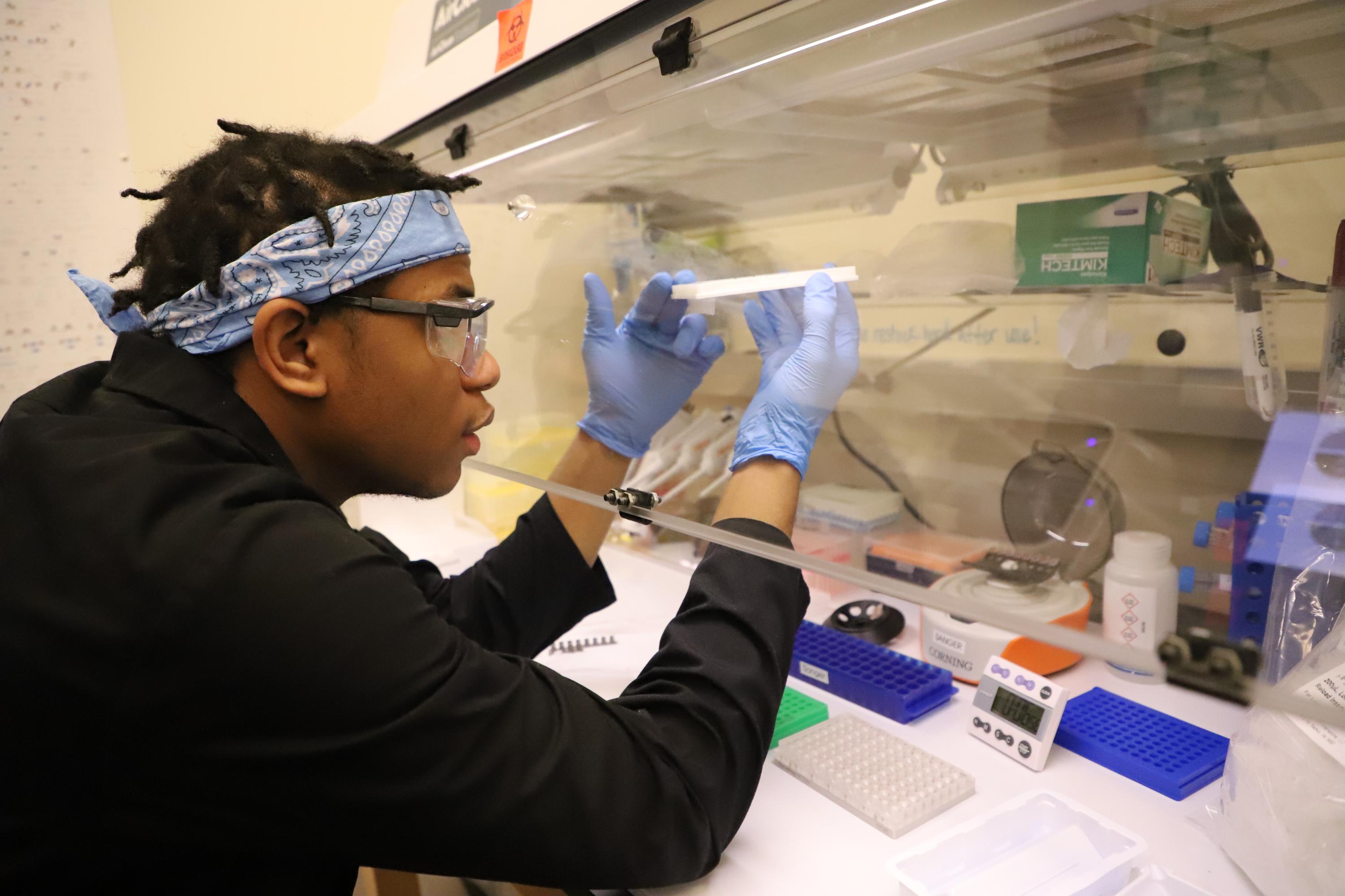 First-year chemical engineering student Aaron Kent examines a sample.