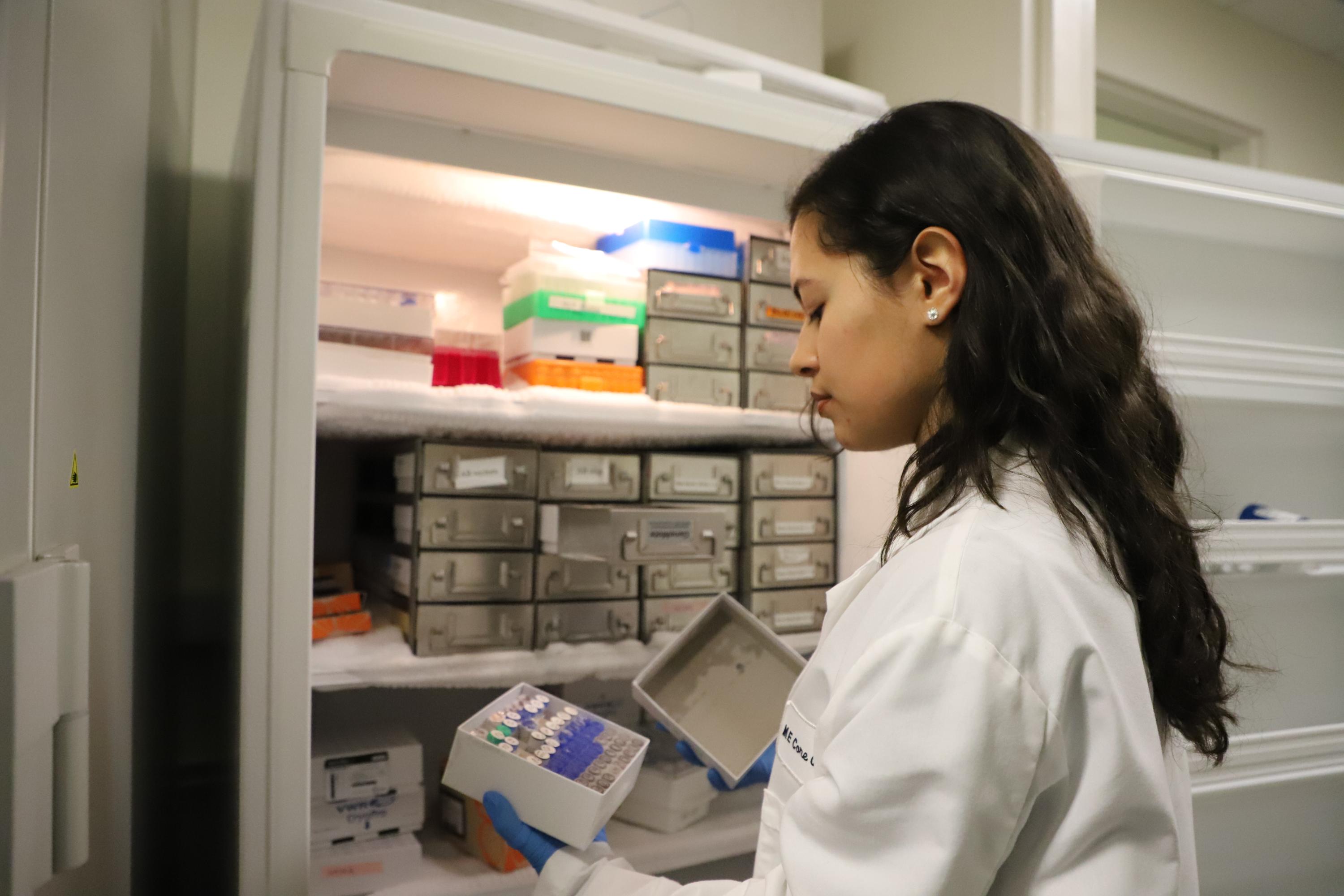 SSI founder and fourth-year biomedical engineering student Nicole Diaz shows how samples are kept in cold storage in the Sanger lab.